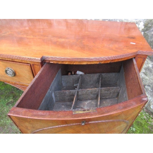 53 - A Regency mahogany bow front sideboard, fitted with a central drawer flanked by cupboard doors, open... 