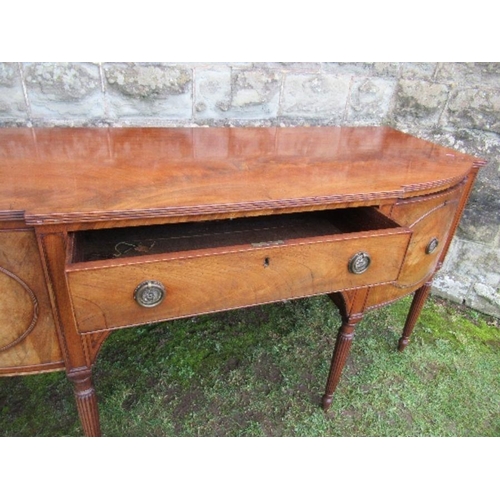 53 - A Regency mahogany bow front sideboard, fitted with a central drawer flanked by cupboard doors, open... 