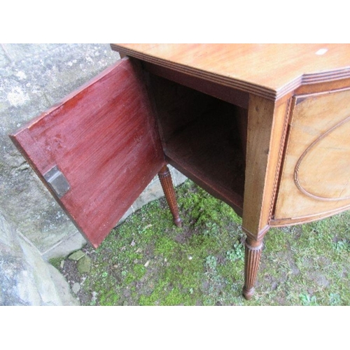 53 - A Regency mahogany bow front sideboard, fitted with a central drawer flanked by cupboard doors, open... 