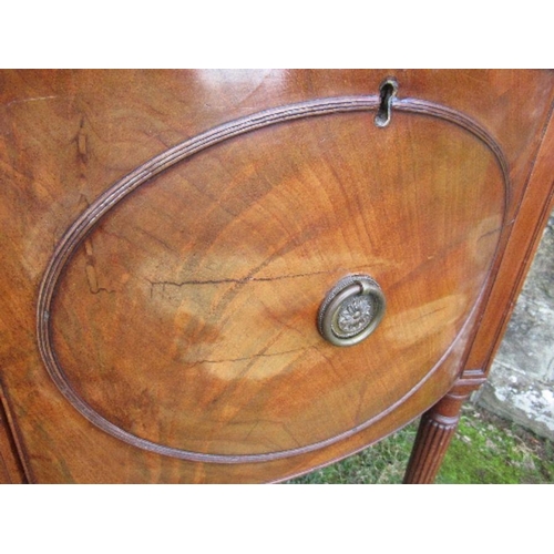 53 - A Regency mahogany bow front sideboard, fitted with a central drawer flanked by cupboard doors, open... 