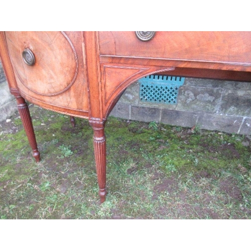 53 - A Regency mahogany bow front sideboard, fitted with a central drawer flanked by cupboard doors, open... 