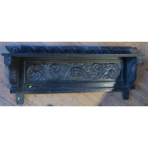 57 - A dark oak over mantel mirror, with carved decoration, 21ins x 60ins