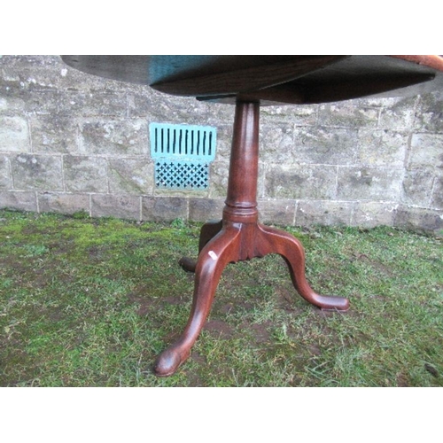 64 - A 19th century mahogany tripod table, raised on a column terminating in three outswept legs, diamete... 