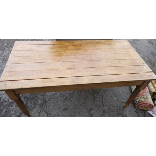 65 - An Antique pine kitchen table, raised on turned legs and casters, 60ins x 30ins, height 29ins