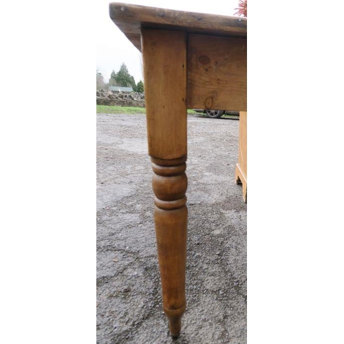 65 - An Antique pine kitchen table, raised on turned legs and casters, 60ins x 30ins, height 29ins