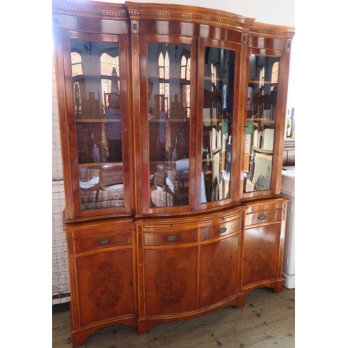 4 - A reproduction yew wood breakfront cabinet, with glazed upper section, fitted with cupboards, drawer... 