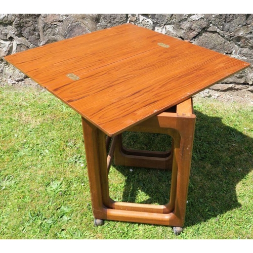 41 - A 20th century nest of tables, the main rectangular table with fold over top, on casters