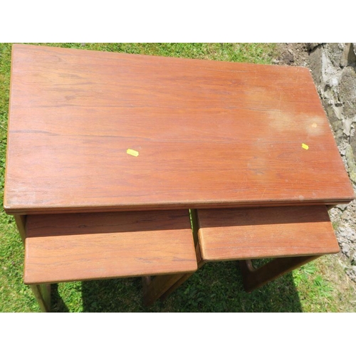 41 - A 20th century nest of tables, the main rectangular table with fold over top, on casters