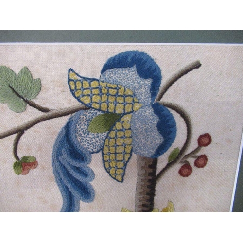 109 - An embroidered picture, of a bird and flowers, framed, 18ins x 20ins