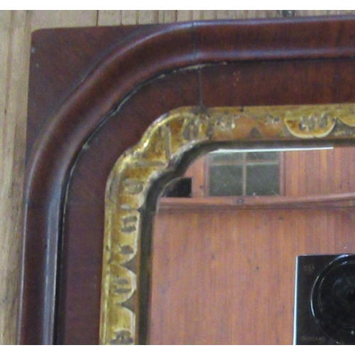 122 - A mahogany framed rectangular wall mirror, with gilt slip, overall size 26ins x 16ins