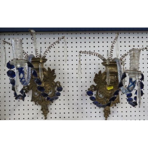 125 - A pair of candle sconces, with a gilt metal mount of a putti holding an urn, with a blue air twist s... 