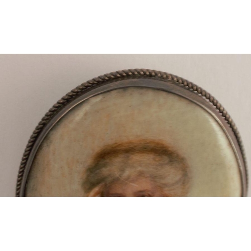 135 - A miniature portrait on ceramic, the reverse monogrammed EM with 1913, the oval panel 6.5cm x 4.7cm