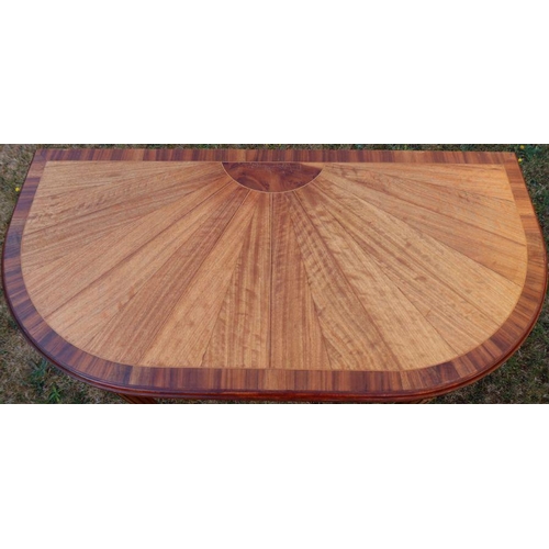 17 - A fold over games table, the top inlaid with yew, American black walnut and mahogany, raised on reed... 