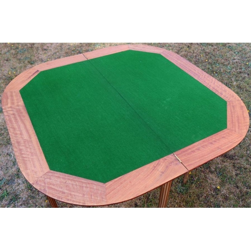 17 - A fold over games table, the top inlaid with yew, American black walnut and mahogany, raised on reed... 