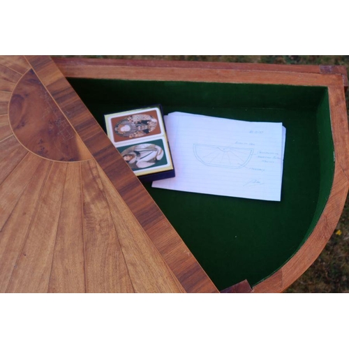 17 - A fold over games table, the top inlaid with yew, American black walnut and mahogany, raised on reed... 