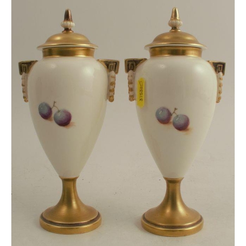 187 - A pair of Royal Worcester covered vases, decorated half round with hand painted fruit by Roberts, sh... 