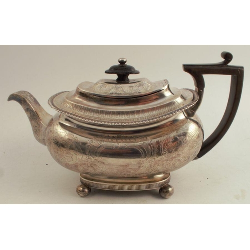 188 - A Georgian silver tea pot, with engraved decoration and initials, raised on ball feet, London 1813, ... 