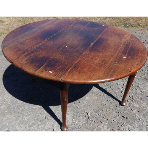 19 - An antique oak gateleg dining table, of oval form, with swing leg action, raised on pad feet, 53ins ... 