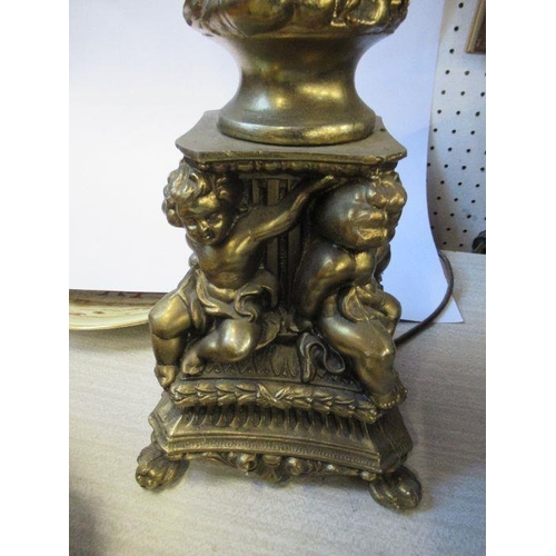 193 - A gilt table lamp, decorated with cherubs