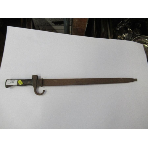 196 - A bayonet with metal scabbard, fullered blade and stud work to the wooden handle