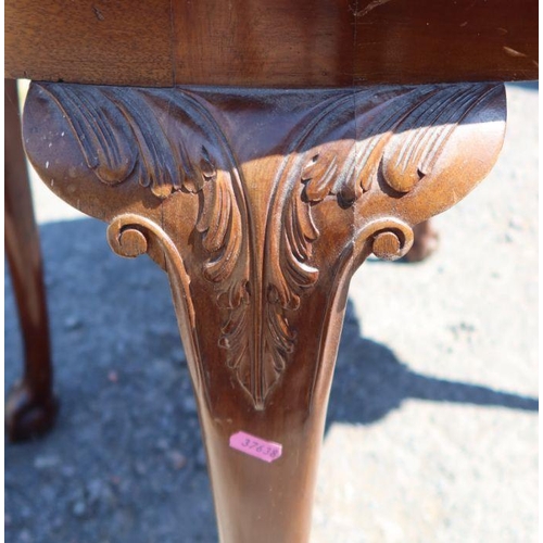 20 - A mahogany quarter veneered oval table, with carved decoration to the scroll leg, terminating in cla... 