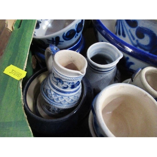 215 - A collection of continental blue and white jugs, tankards, bowls, etc.