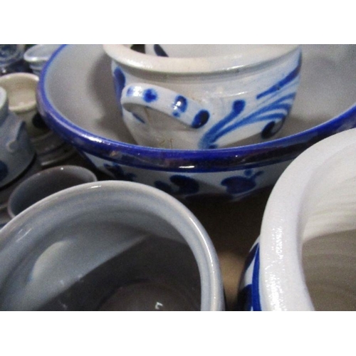 215 - A collection of continental blue and white jugs, tankards, bowls, etc.