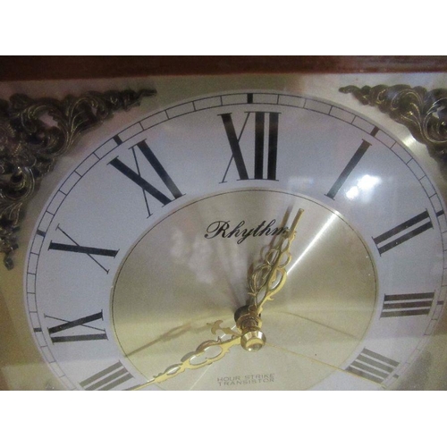 225 - A modern wooden cased mantel clock, the dial marked Rhythm