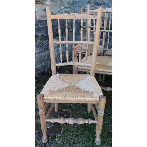 23 - A set of eight (6 + 2) pine dining chairs, with rush seats and bar backs