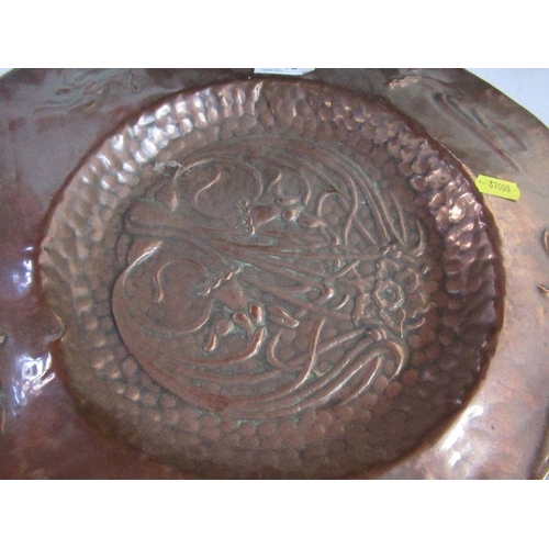 245 - An Arts and Crafts circular copper wall plate, decorated with flowers, diameter 15ins