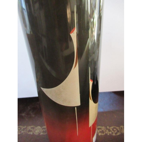 248 - An Oriental cylindrical vase, with stylised stork decoration to a red and black ground, height 11ins... 