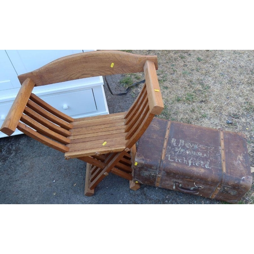 26 - A modern oak cross framed armchair, together with a trunk