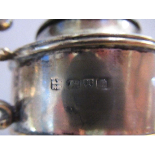 297 - A hallmarked silver urn, with hinged cover pair of handles and raised on a pedestal foot, weight 5oz... 