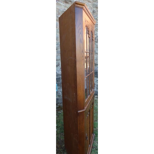 38 - A reproduction oak floor standing corner cupboard, with glazed upper section and cupboard base, havi... 