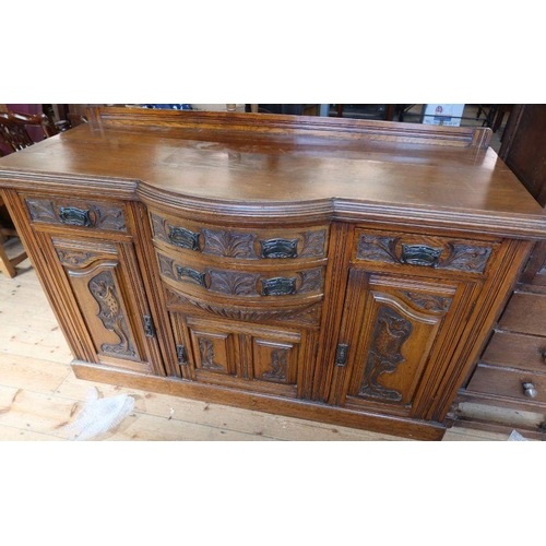 4 - An Edwardian oak sideboard, fitted with drawers and cupboards, having carved decoration, width 60.5i... 