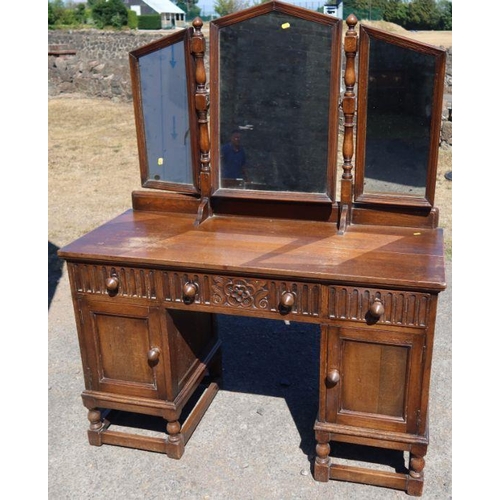 6 - A reproduction oak dressing table, with three mirrors, fitted drawers and cupboards, width 49ins