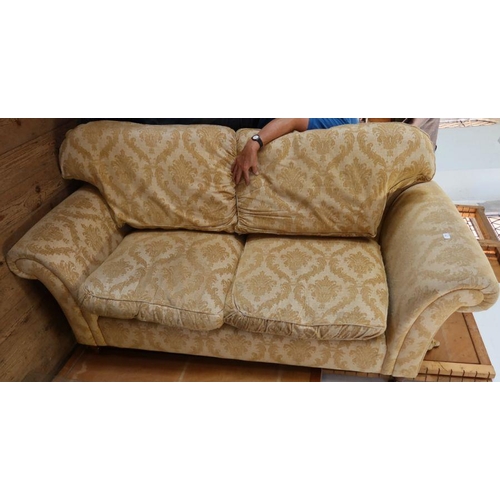 61 - A pair of three seater sofas, in gold patterned upholstery, with fire labels