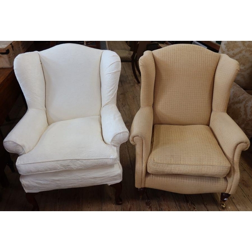 62 - A Multiyork wing back armchair, with fire labels, together with another wing back armchair, with fir... 