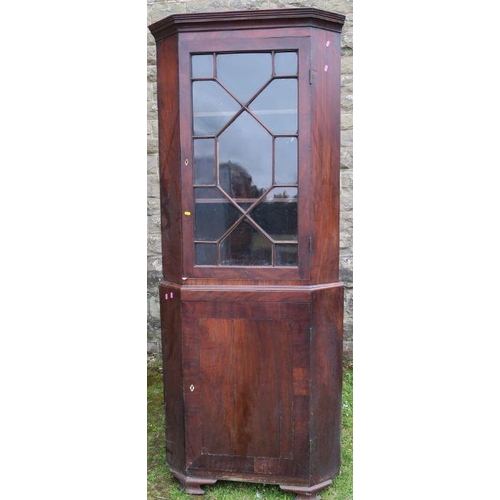 9 - A 19th century mahogany free standing double corner cupboard, the upper section having astragal glaz... 