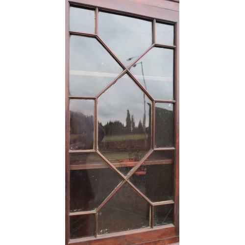 9 - A 19th century mahogany free standing double corner cupboard, the upper section having astragal glaz... 