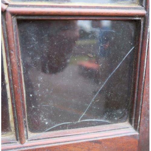 9 - A 19th century mahogany free standing double corner cupboard, the upper section having astragal glaz... 