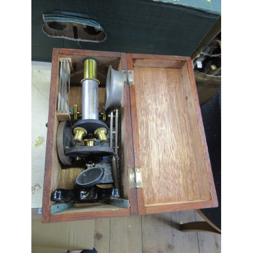 220A - A small microscope, boxed, with small selection of slides and accessories