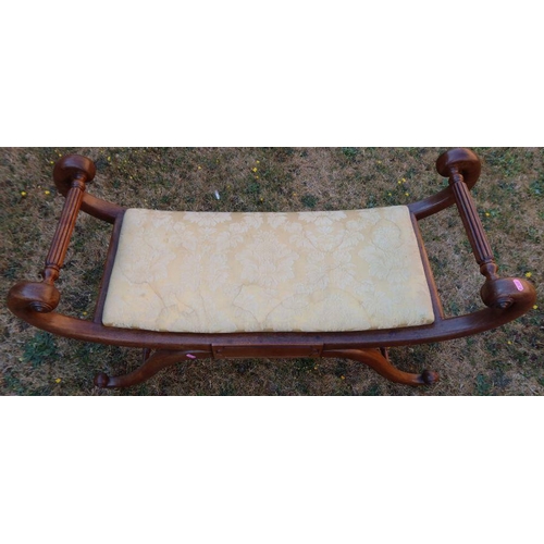 112 - A Regency design mahogany window seat, with scroll ends and upholstered seat, raised on a cross base... 