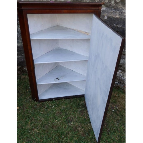 117 - A walnut corner cupboard, the inlaid door opening to reveal shelves, height 37ins x width 25.5ins x ... 