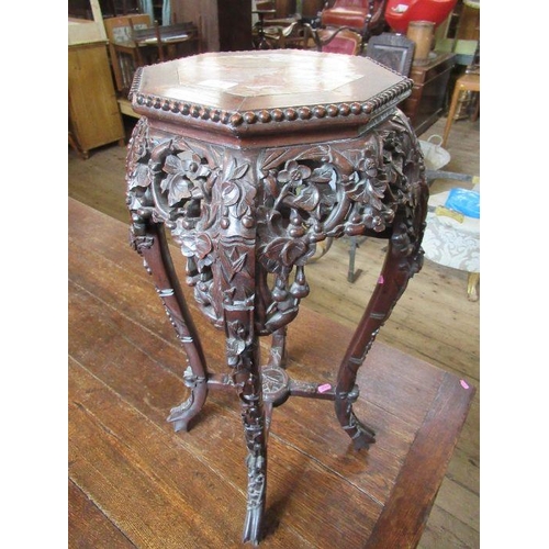 2 - An Oriental hardwood jardiniere stand, the octagonal top inset with marble and having a bead edge, t... 