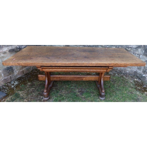 24 - An antique oak refectory dining table, fitted with a frieze drawer, raised on end supports united by... 