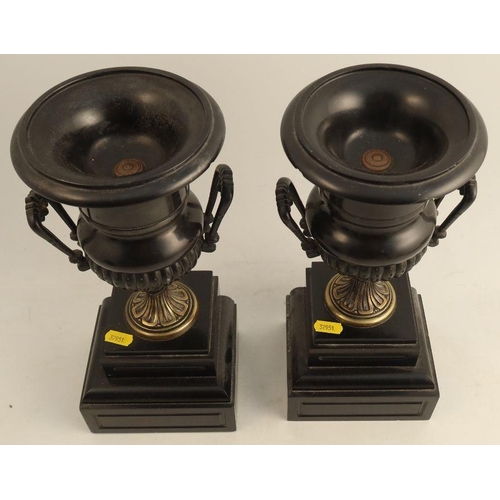 245 - A pair of 19th century mantel urns, in black and gold, on stepped square bases, height 12.5ins