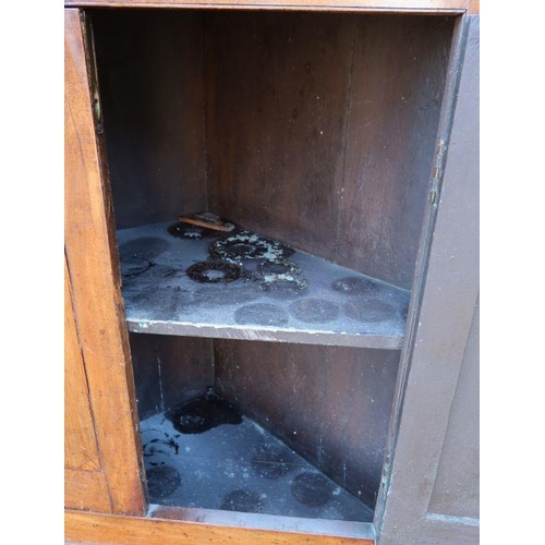 36 - A 19th century mahogany floor standing corner cupboard, the upper section with a pair of glazed door... 