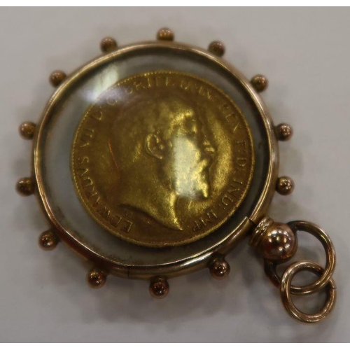 411 - A 1902 gold half sovereign, a gold and glass locket pendent