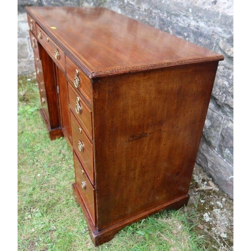 52 - An Edwardian desk, with cross banded decoration, fitted with a central frieze drawer flanked by two ... 